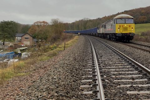 DC Rail train with two class 56 diesels at the head hauling an aggregates train over the tracks at Dronfield