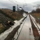 flooding railway tracks disappearing into the distance