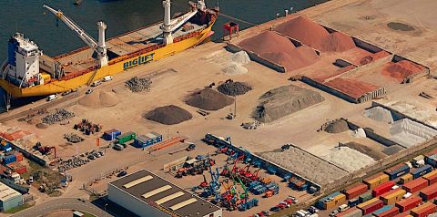 Sky view of the Rotim Bulk Terminal, in the Vlothaven port in Amsterdam with mountains of red granite from Scotland