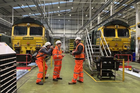 Tom Heap (on right) from Sky News interviews Freightliner staff inside crewe maintenance depot